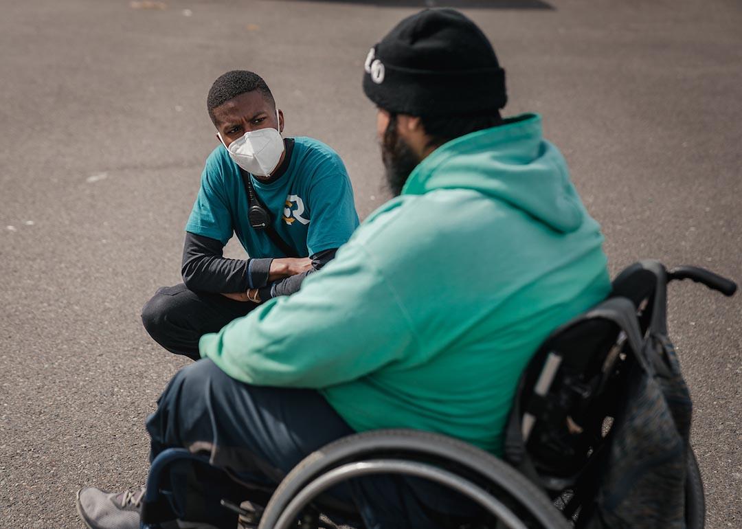 Crisis responder Chris Jones, left, talks with a community member in Olympia, WA.