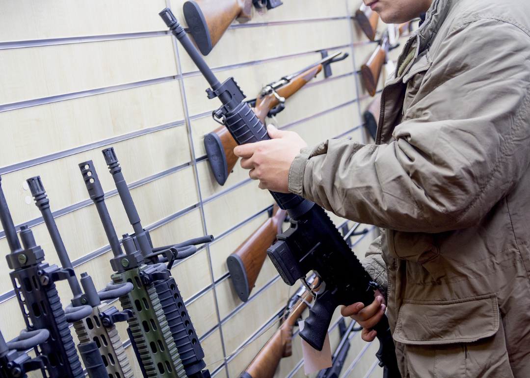 Man with an automatic rifle at the store.