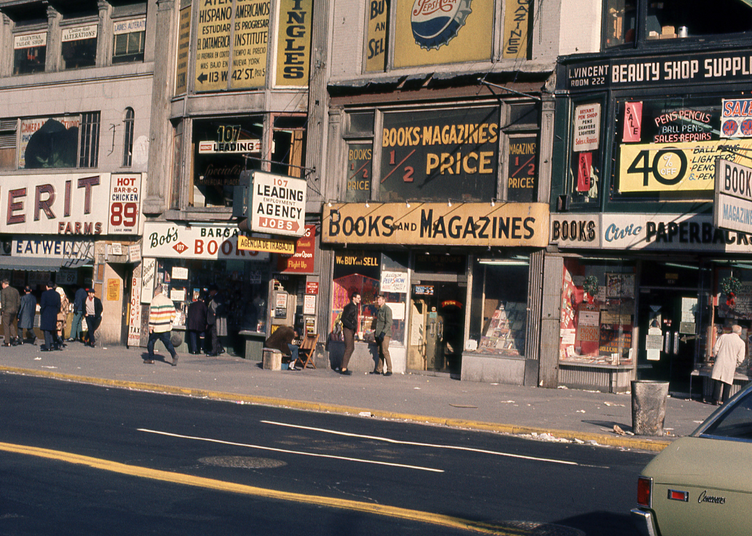 View of book stores, employment agencies, and beauty supply shops line 42nd Street in Manhattan's Times Square, New York, New York, March 1, 1970.