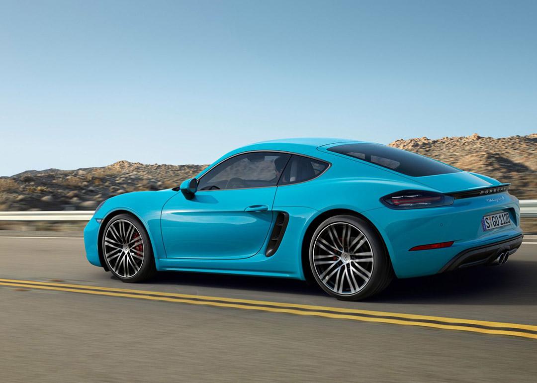 A Miami blue Porsche 718 Cayman on the road.