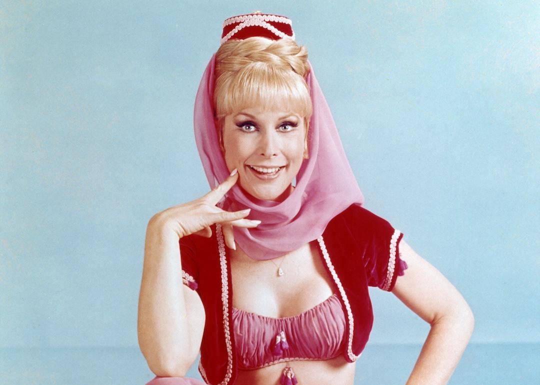 Barbara Eden in costume sitting on a multi-coloured pile of cushions in a publicity portrait for the US television series 'I Dream of Jeannie', circa 1967.