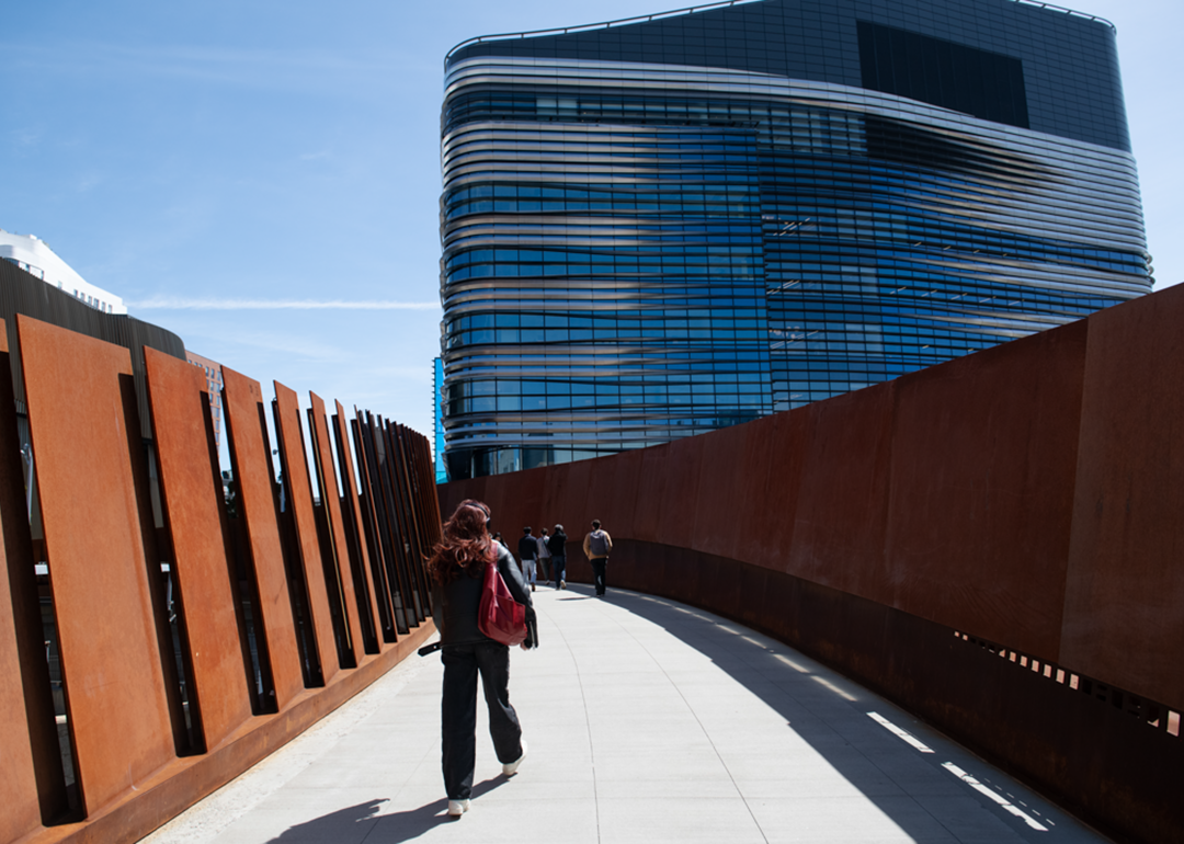 Students cross a pedestrian bridge to the EXP building at Northeastern University, which houses science, engineering and computational research departments.