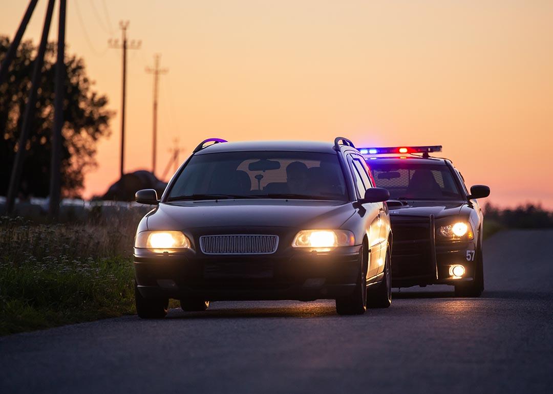 Car on the road being followed by police.