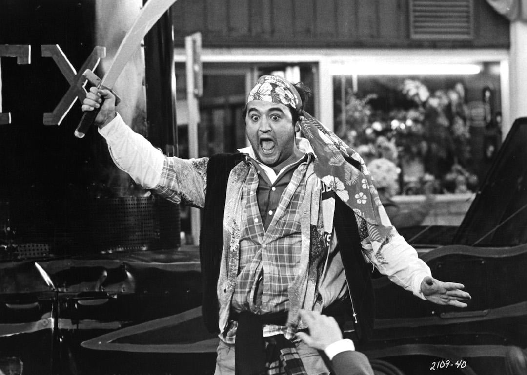 John Belushi leads the destruction wrought upon the annual homecoming parade in a scene from the 1978 college film 'Animal House.'