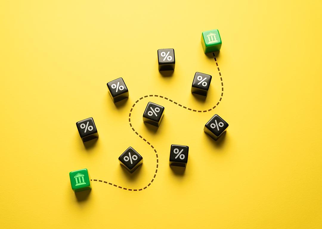 Money and stocks transfer represented by ten pieces of dice on a yellow background.