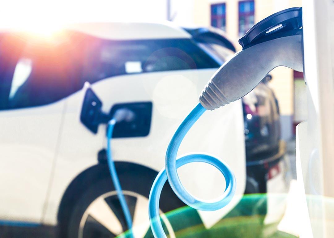 Closeup of an EV's charger nozzle while the car is being recharged at a station.