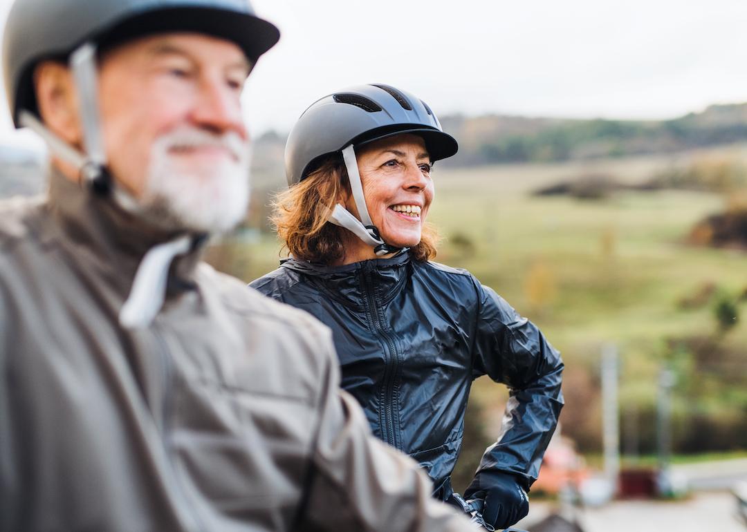 Active retired couple with bike helmets on.