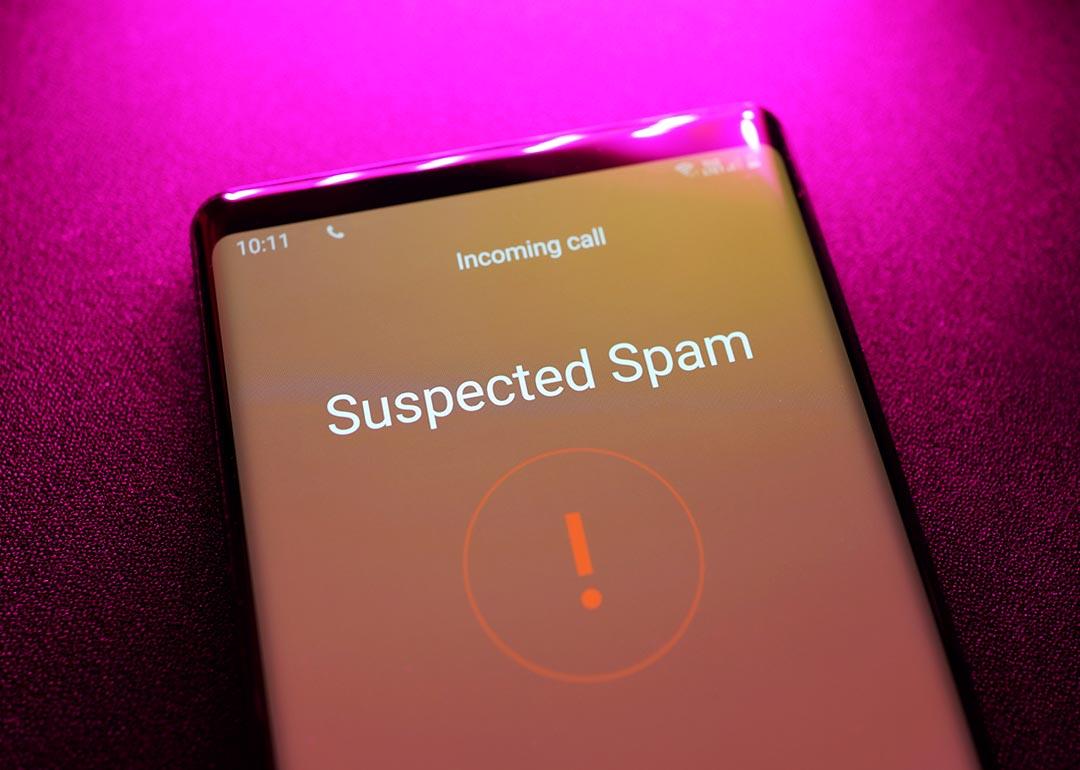 A phone displaying detection of an incoming call as a suspected spam.