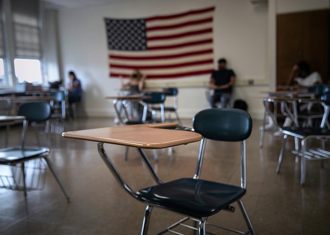 An empty chair in a sparsely attended high school classroom in Stamford Connecticut practicing hybrid learning during the pandemic.