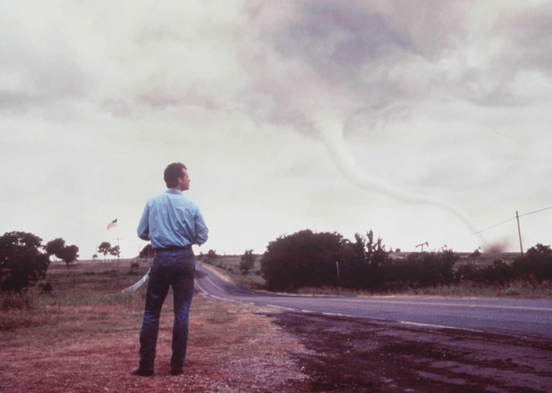Bill Paxton watching a tornado forming in a scene from thriller movie 'Twister' (1996)