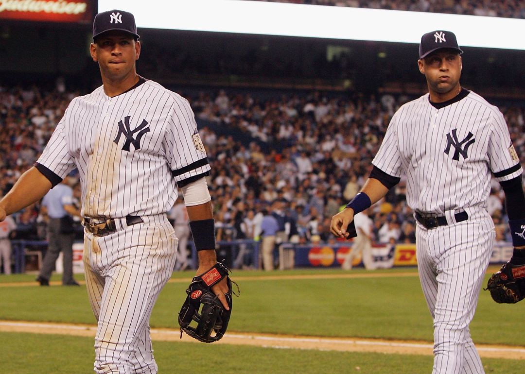 Alex Rodriguez #13 (L) and Derek Jeter #2 of the New York Yankees walk back to the dugout at Yankee Stadium, circa 2008