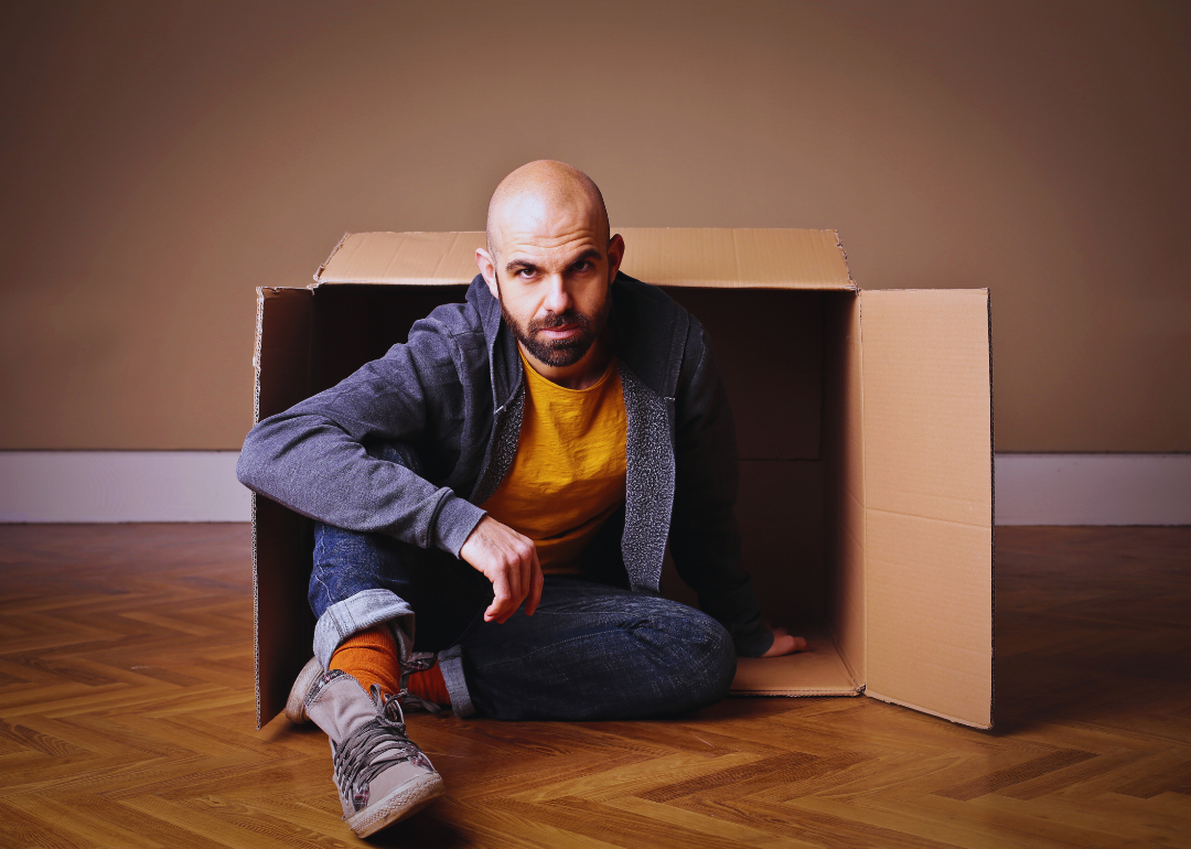 Man emerging from a cardboard box.