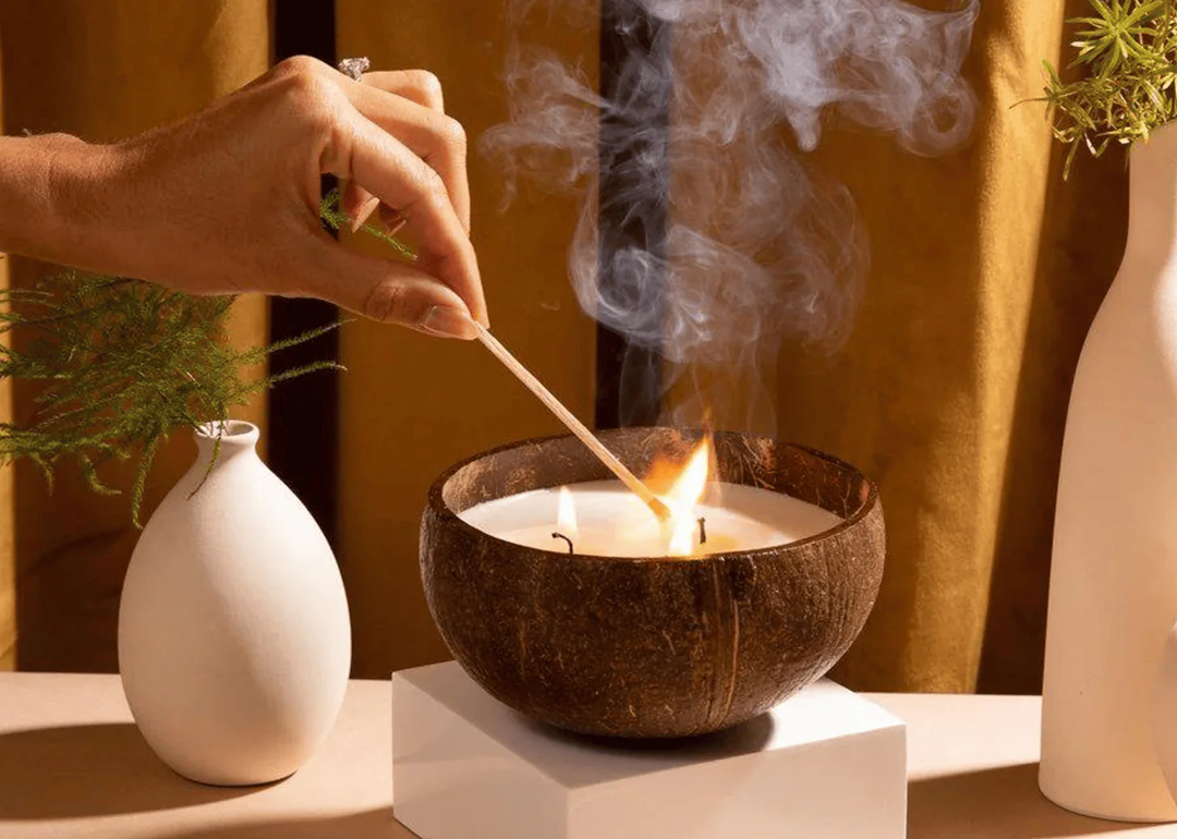 A coconut candle being lit.