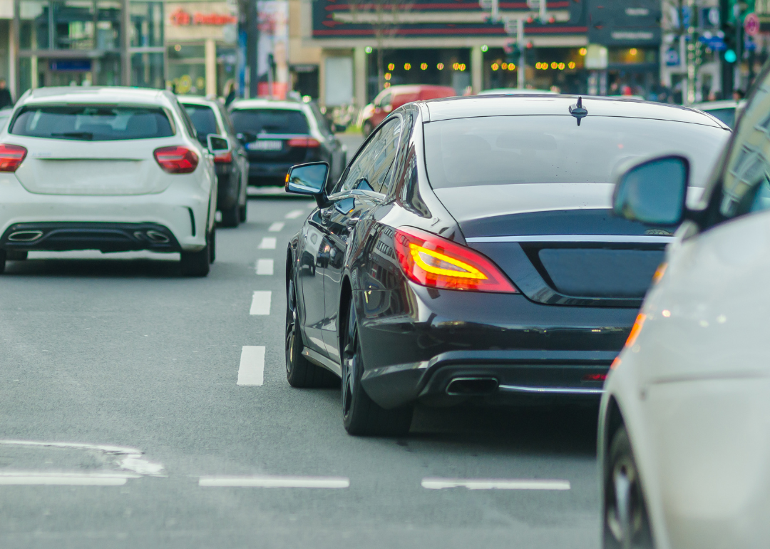 A busy street with cars changing lanes