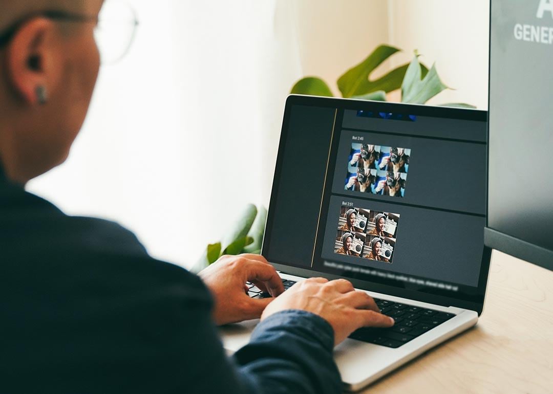 Person creating photo art with Artificial Intelligence software on computer. 