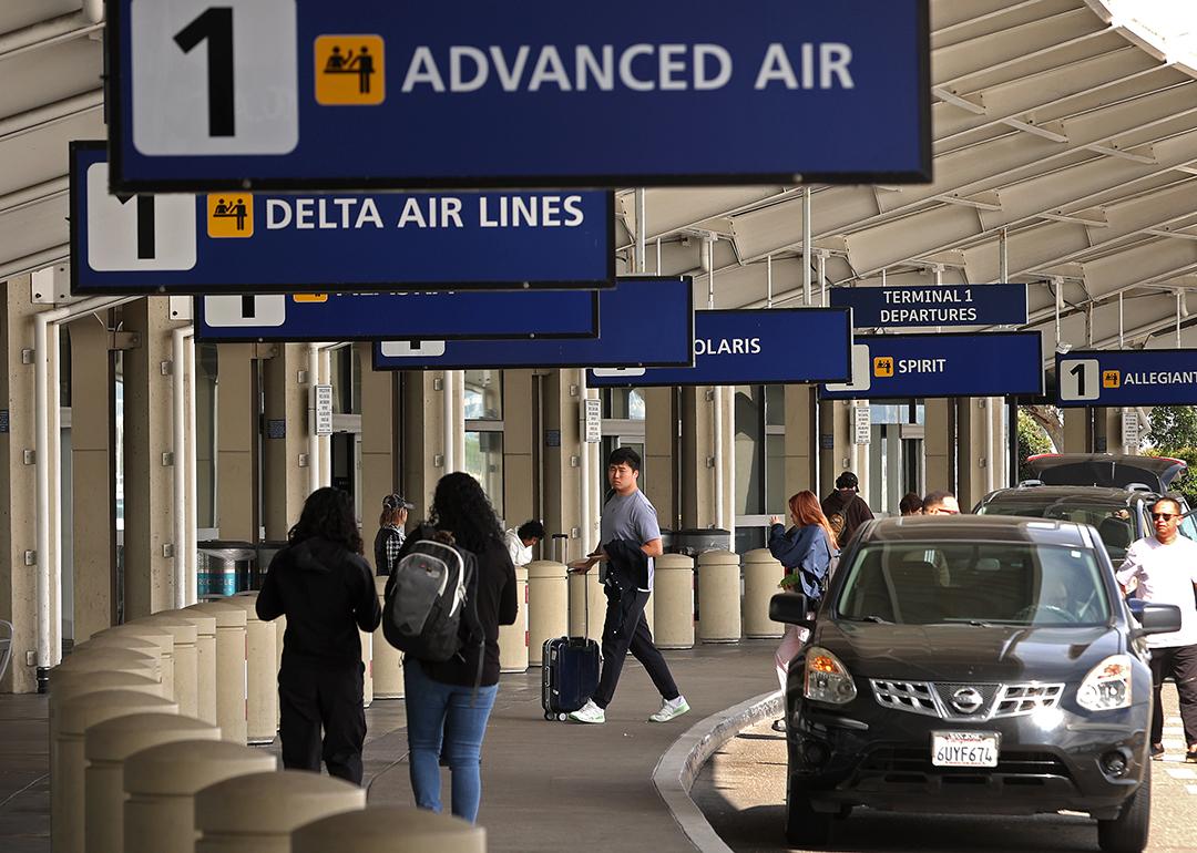 Travelers walk towards Terminal 1 at Oakland International Airport, California.