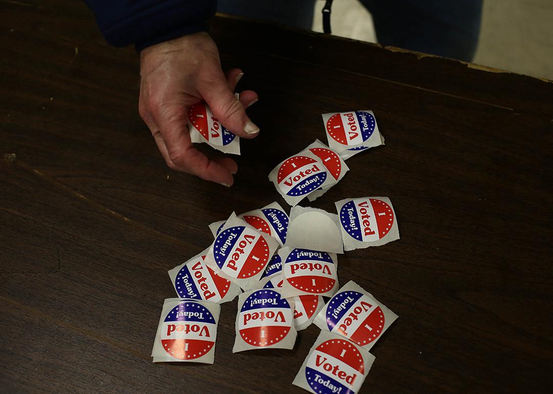 A voter takes a sticker after casting a ballot at a polling station during the 2014 mid-term elections in St. Clair Shores, Michigan.