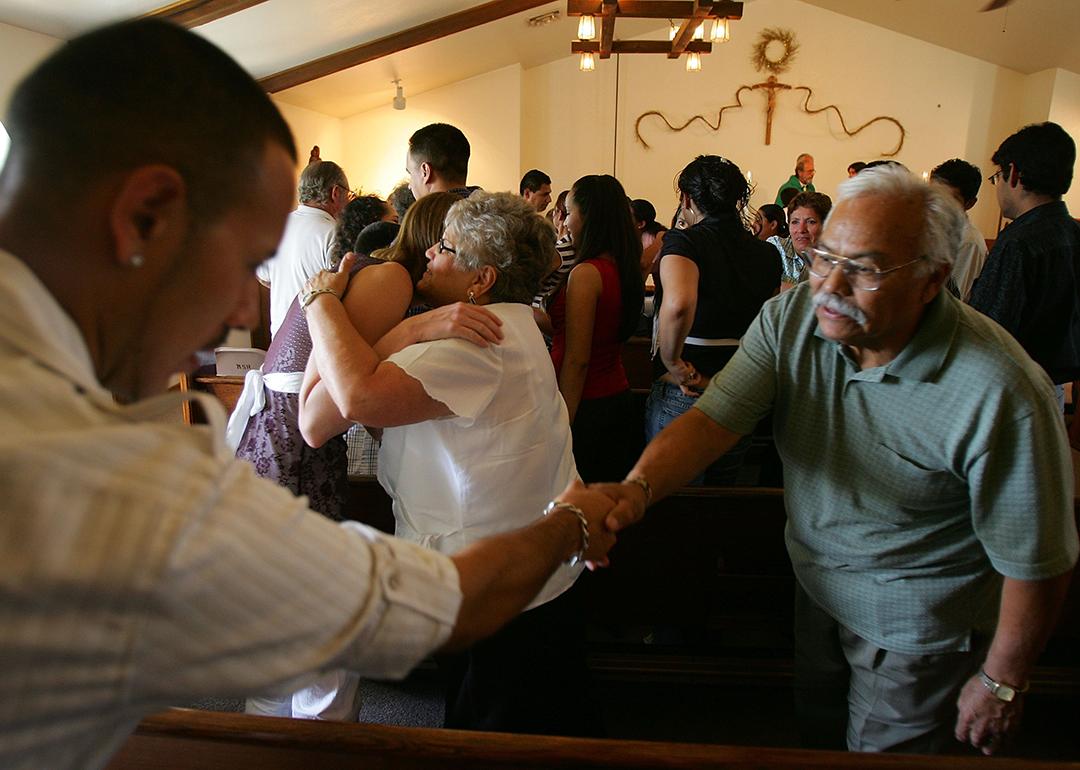 Parishioners greet each other during the English/Spanish bilingual mass at Mission San Rafael Catholic near Huntington, Utah.