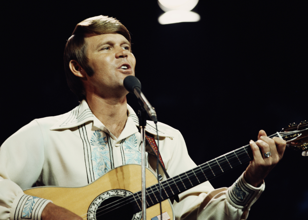 American singer Glen Campbell performs on a TV show in London, circa 1974.