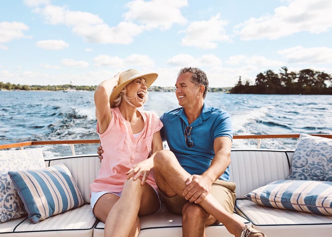 Retired couple sits on a boat on a lake in the Midwest.