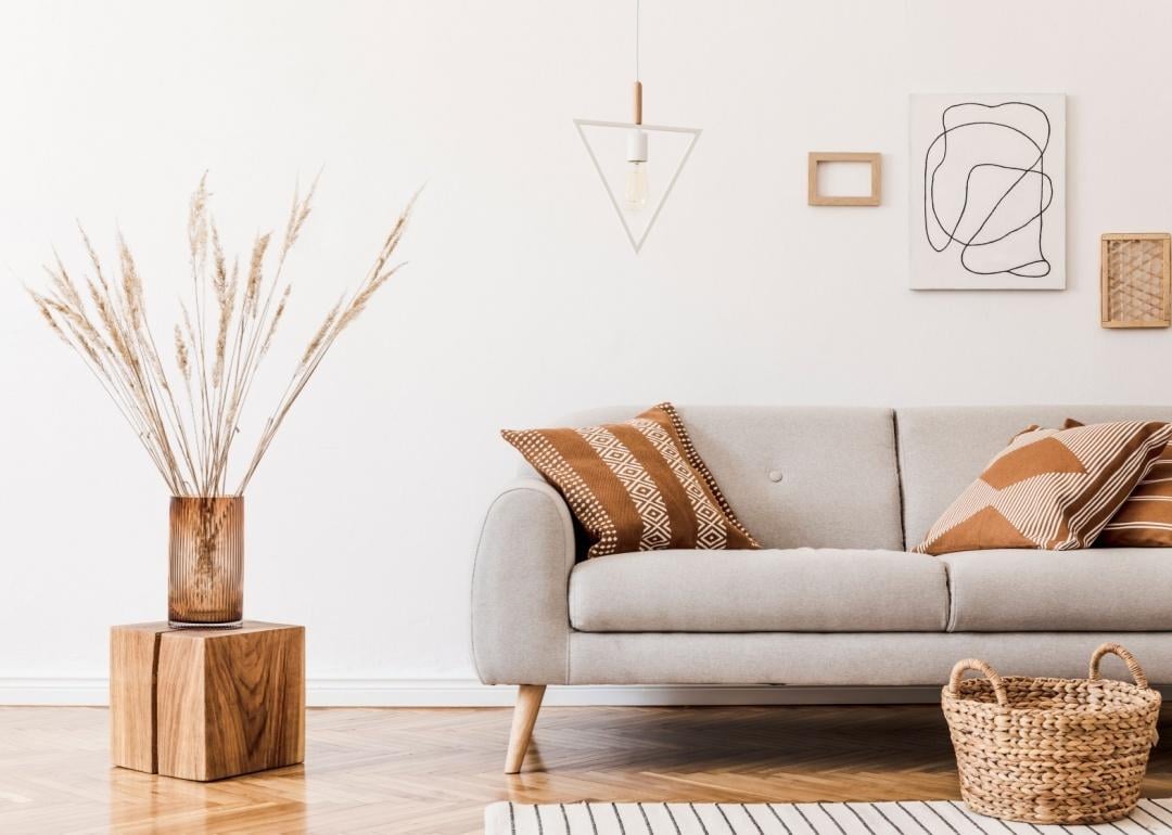 A living room with a modern gray couch and wood decor elements.