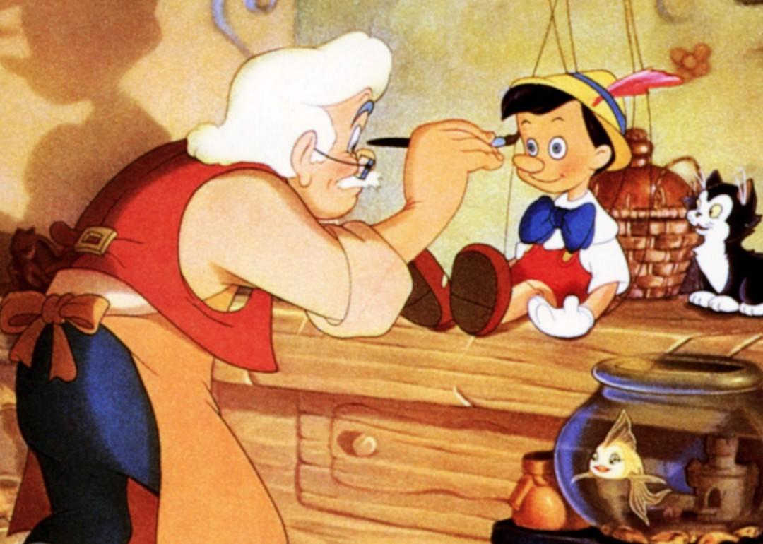 Gepetto paints Pinocchio sitting next to his cat Figaro in the 1940 movie 'Pinocchio.'