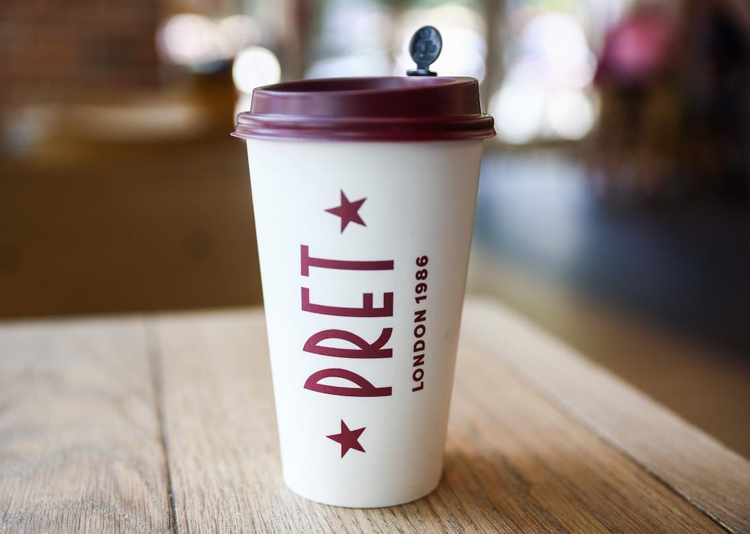 A paper coffee cup is seen on a table in Pret A Manger shop in Manhattan in 2024.