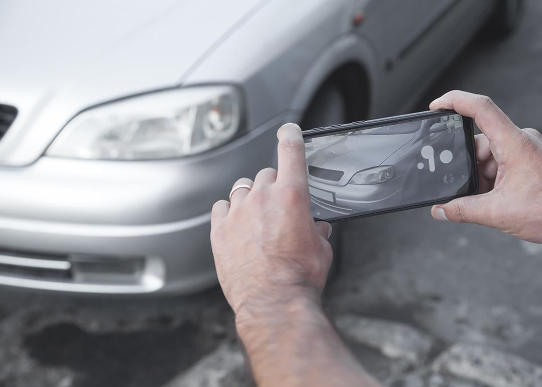 Picture of a car for sale being taken using a smartphone.