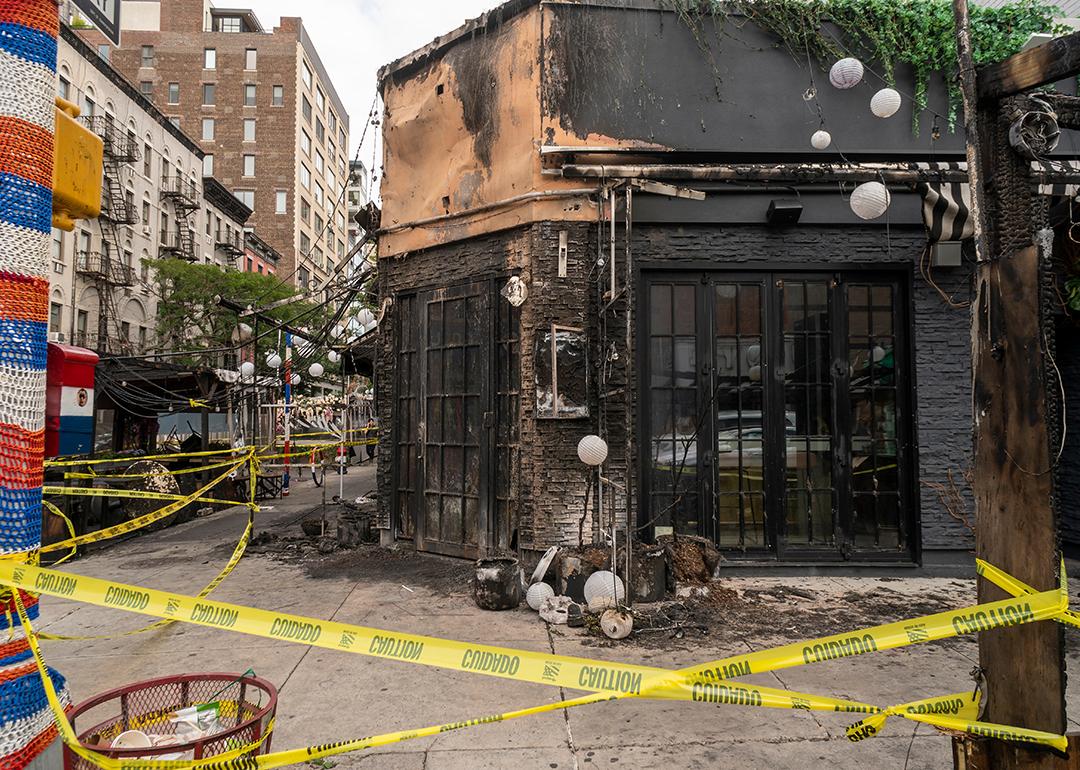 The remains of the outdoor dining and facade of a restaurant after a fire in Chelsea, New York.