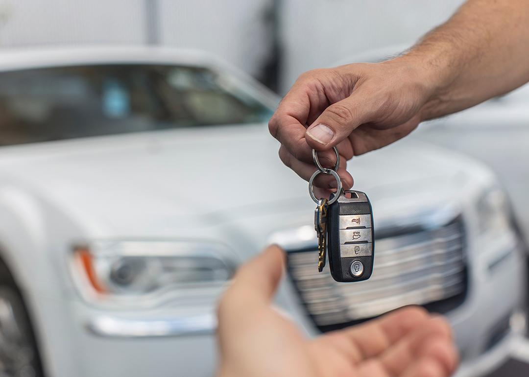 A man returns car keys at a dealership.