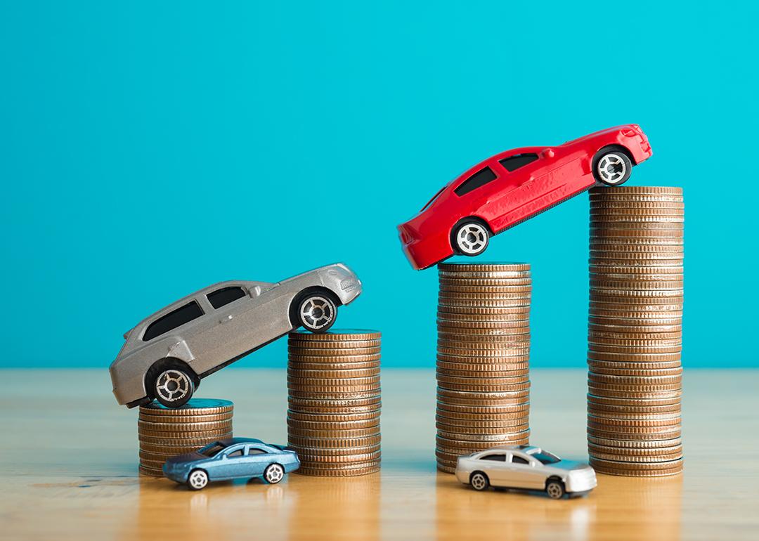 Car figures rising on top of coins.