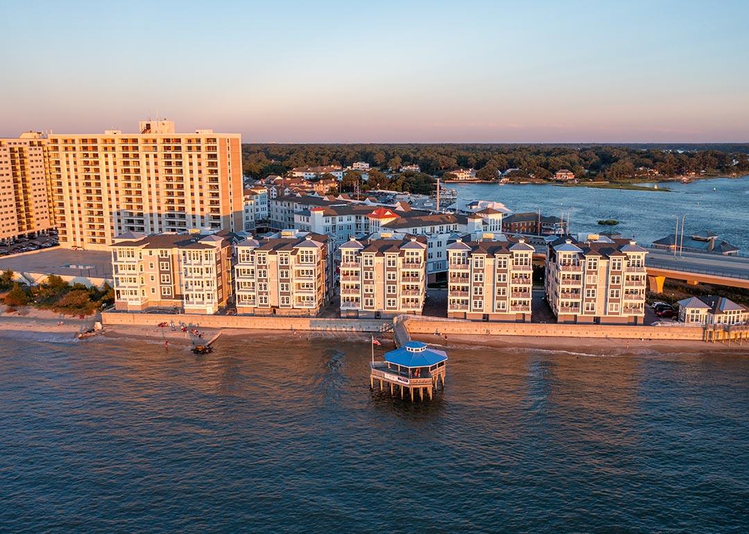 Aerial view of condos and a pier in Virginia Beach, Virginia at sunset.