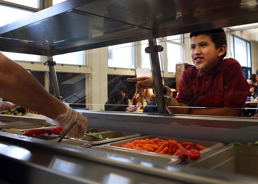 Moises Gaspar chooses his lunch as he takes part in the nutrition program at Bradley Elementary school in East Boston.