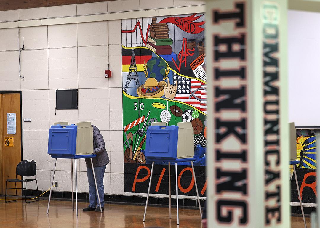 A voter cast their ballot in the Michigan primary election at Dearborn High School.