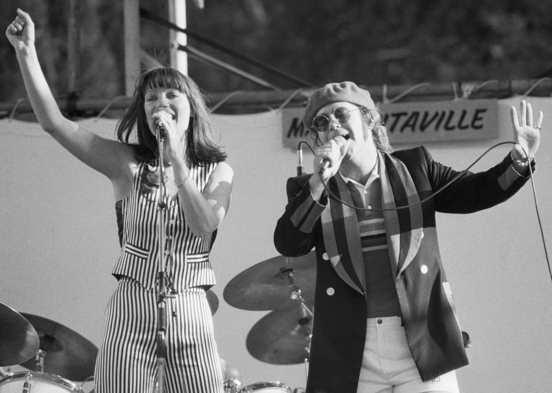 Singers Kiki Dee and Elton John perform at the Dr Pepper Music Festival at New York City's Central Park, 1977.