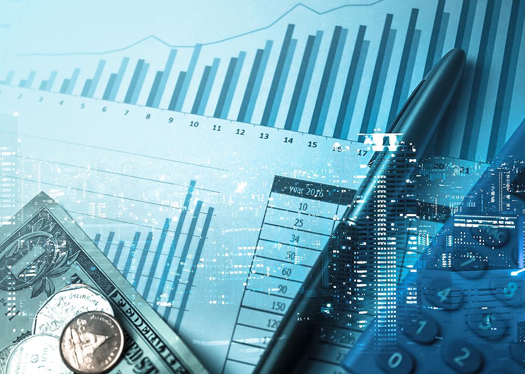 Conceptual image of business finance showing a city, money and growing charts.