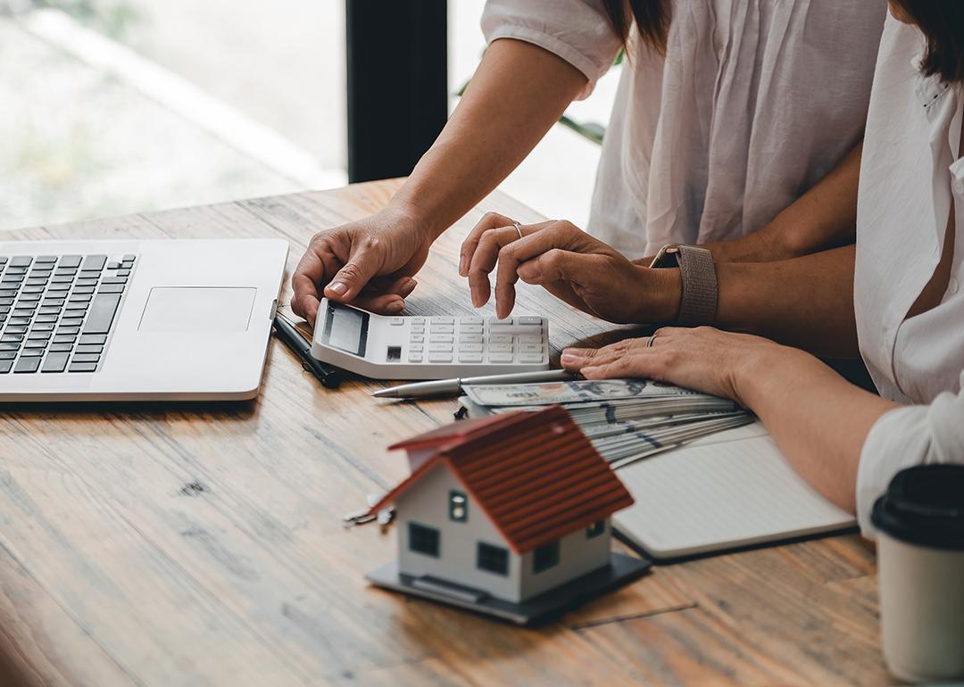 Millenial couple calculating mortgage and expenses.