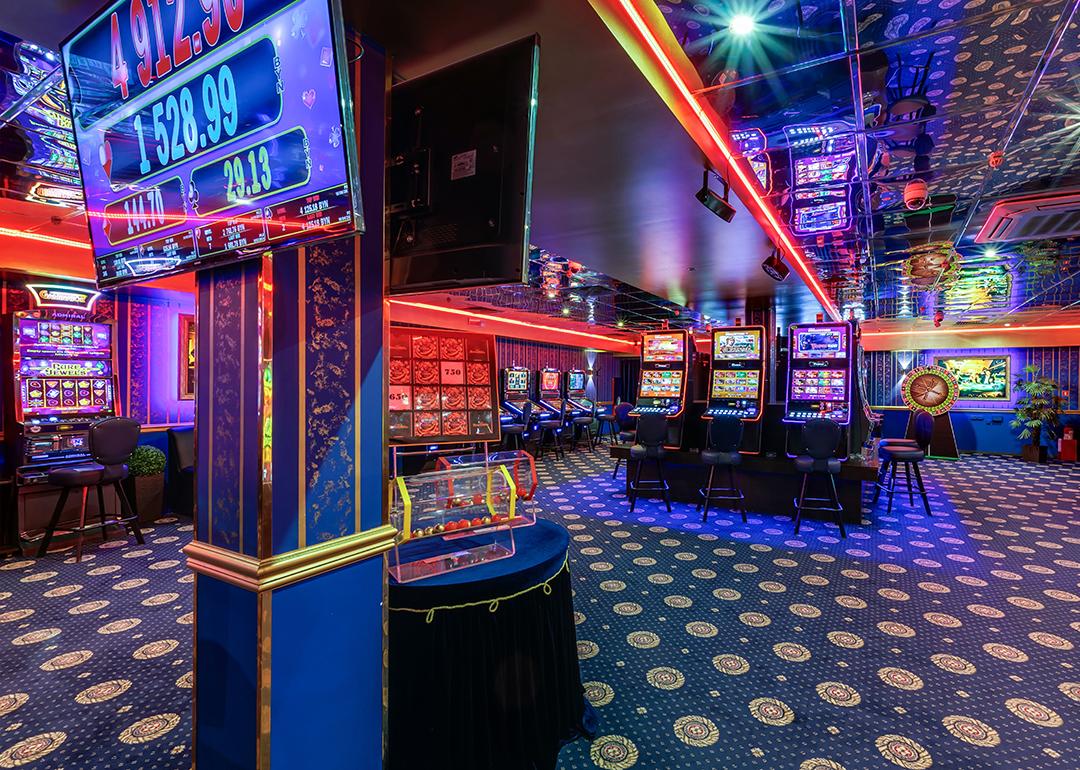 Interior of an elite Russian casino in Las Vegas with gaming machines and poker tables.