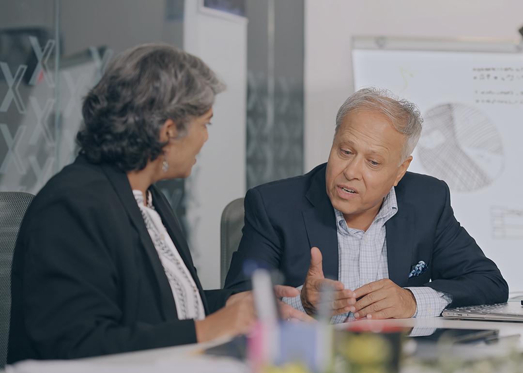 Senior male professional engaged in an intense conversation with coworker.