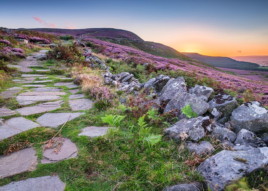 Simonside Hills path for hikers and walkers during sunset in Northumberland National Park, England.