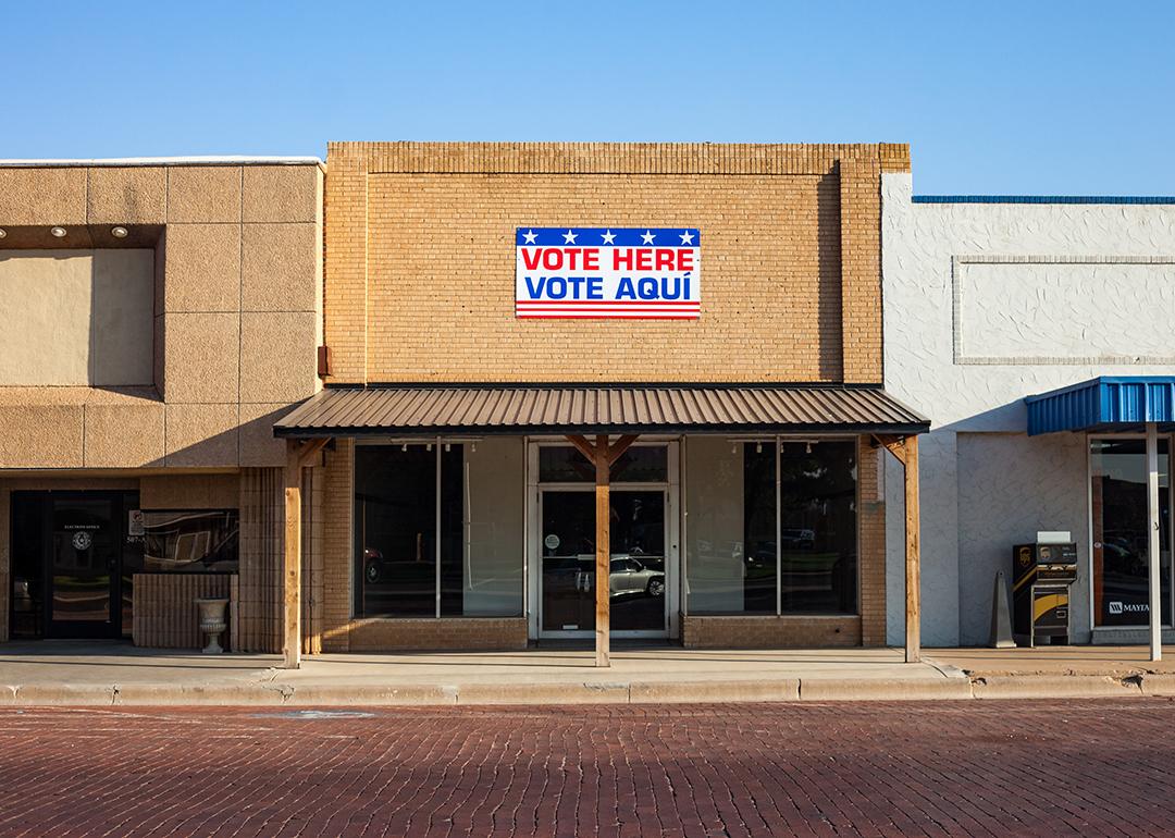 An election polling station with a "Vote Here"/"Vote Aqui" sign.