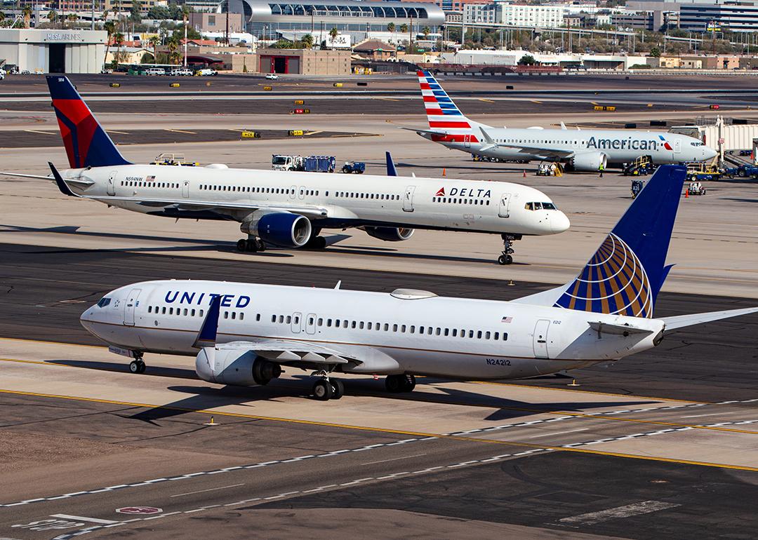 United, Delta and American Airlines planes line up in Phoenix Sky Harbor International Airport.