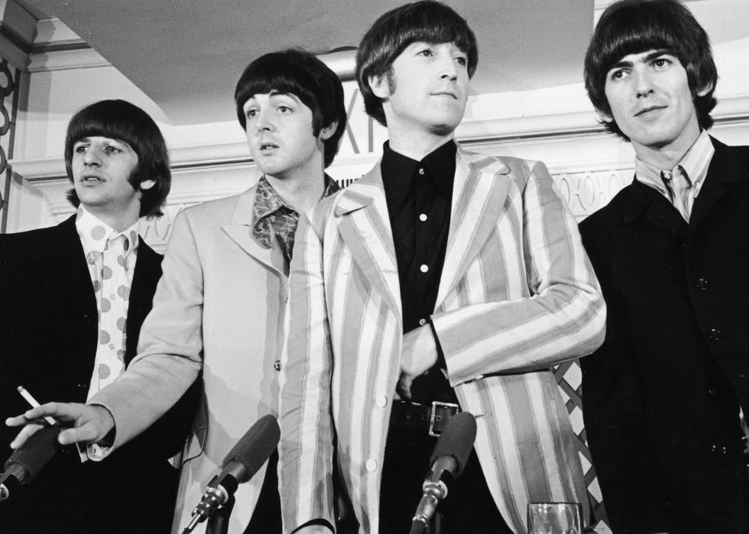 The Beatles—from left, Ringo Starr, Paul McCartney, John Lennon, and George Harrison—standing in front of four microphones in New York 1966.