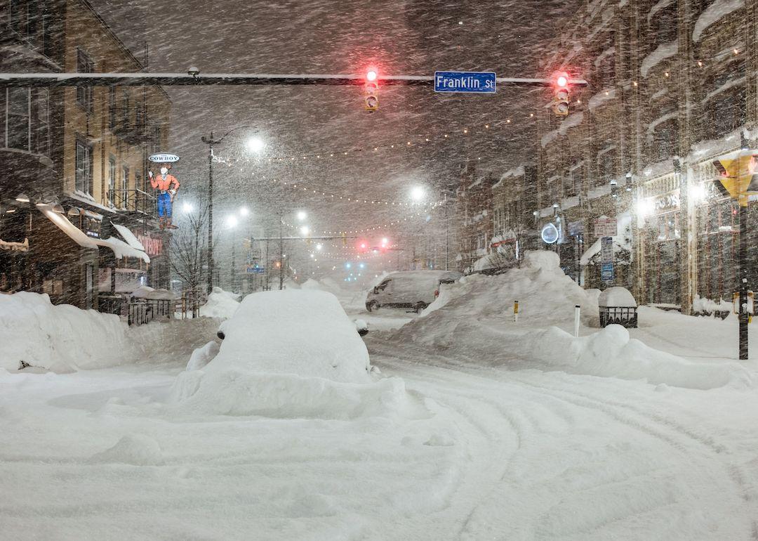 Vehicles are seen abandoned in heavy snowfall in downtown Buffalo, New York, on Dec. 26, 2022.