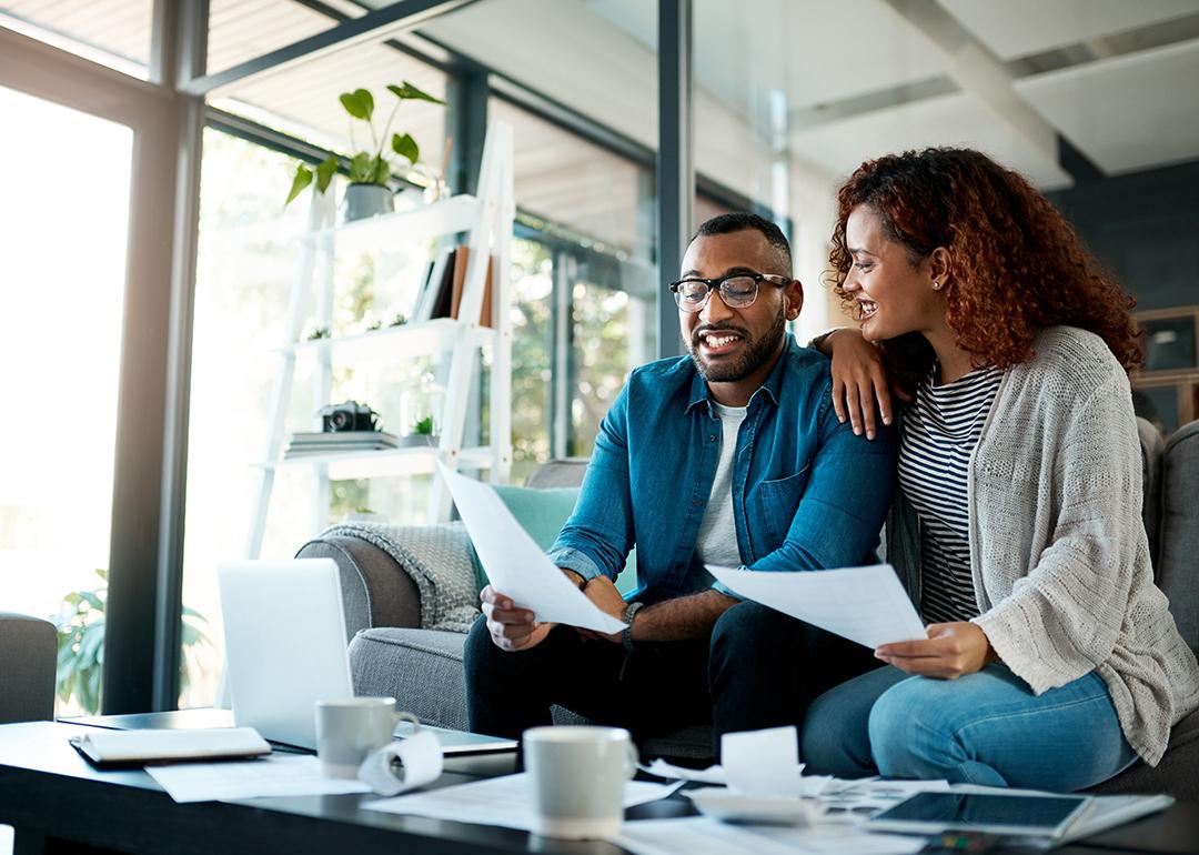 Couple happily discussing finances.