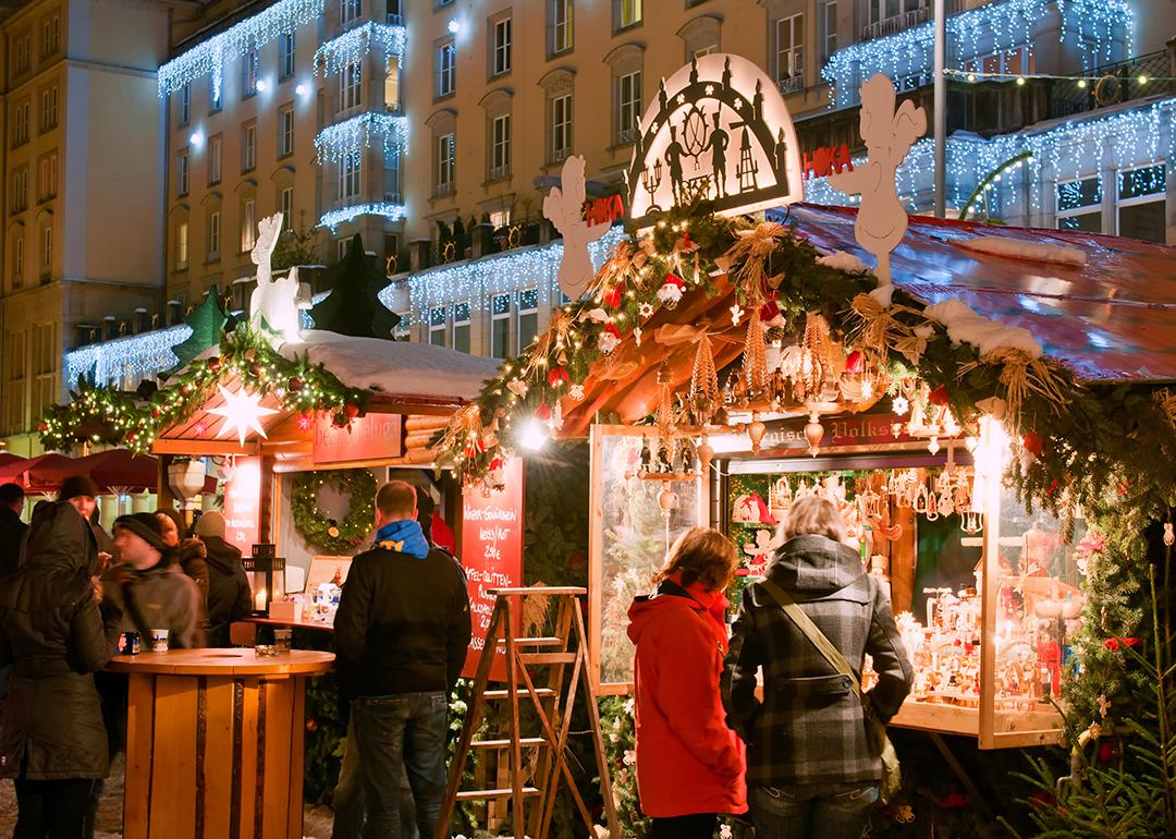 People shopping around stalls during holiday season in Dresden, Germany where there is the older Christmas market.