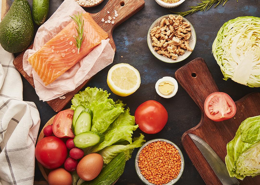 Salmon, walnuts, fruits and vegetables rich in phytoestrogens and fatty acids laid on a table for meal prep.