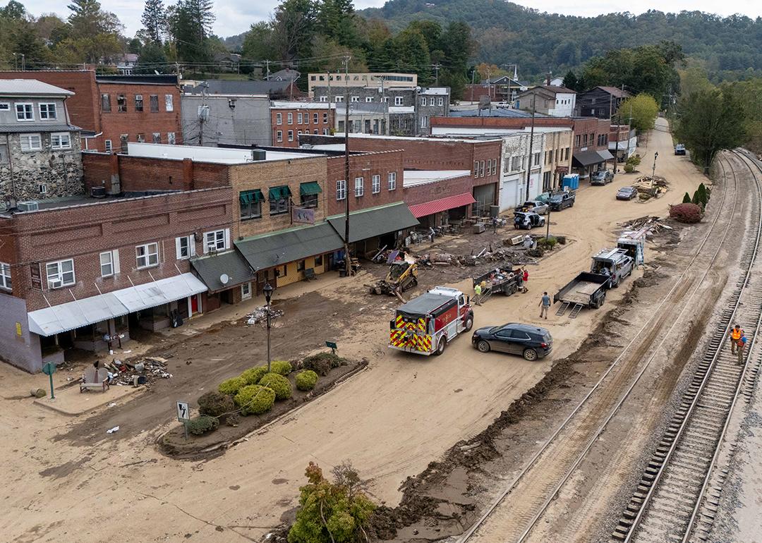 Debris and river mud being hauled off the French Broad River area after Hurricane Helene in Marshal, NC.