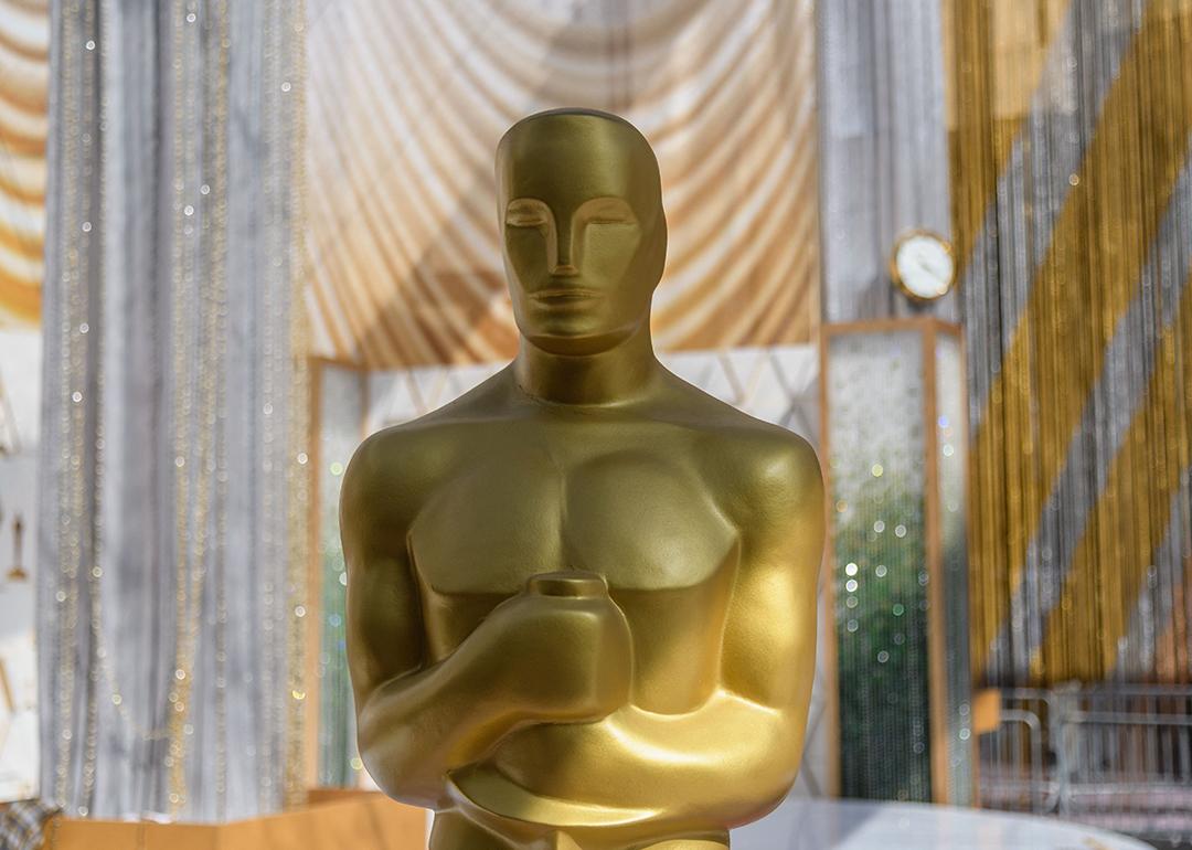 An Oscar statuette displayed near the red carpet area of an Oscars Award show.