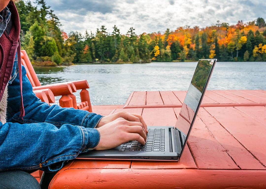 A remote worker using a laptop outdoors.